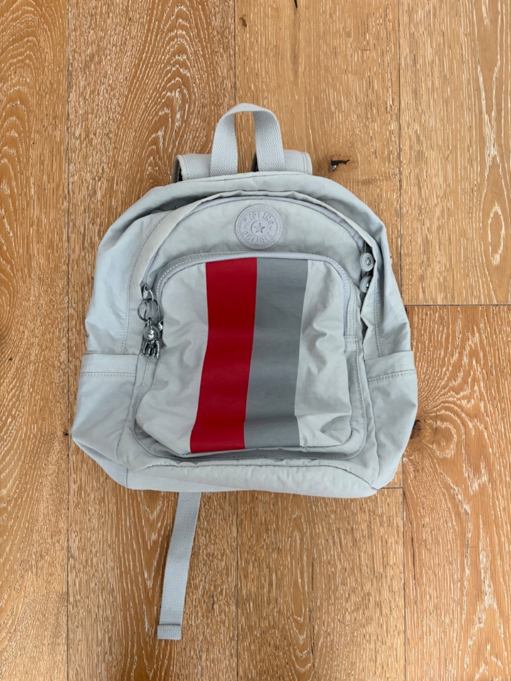 Grey Kipling backpack with monkey keychain